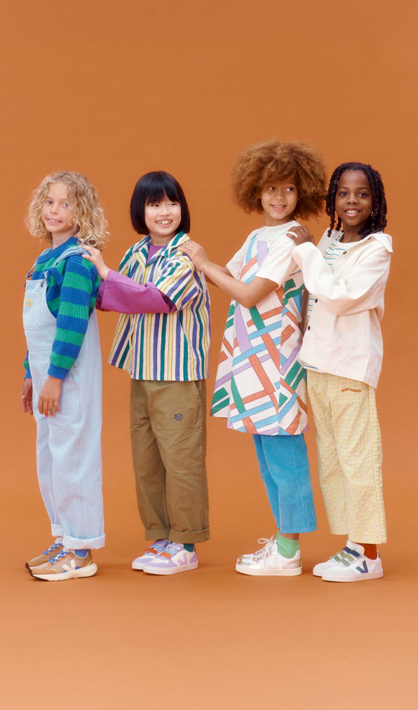 Four kids wearing Veja sneakers
